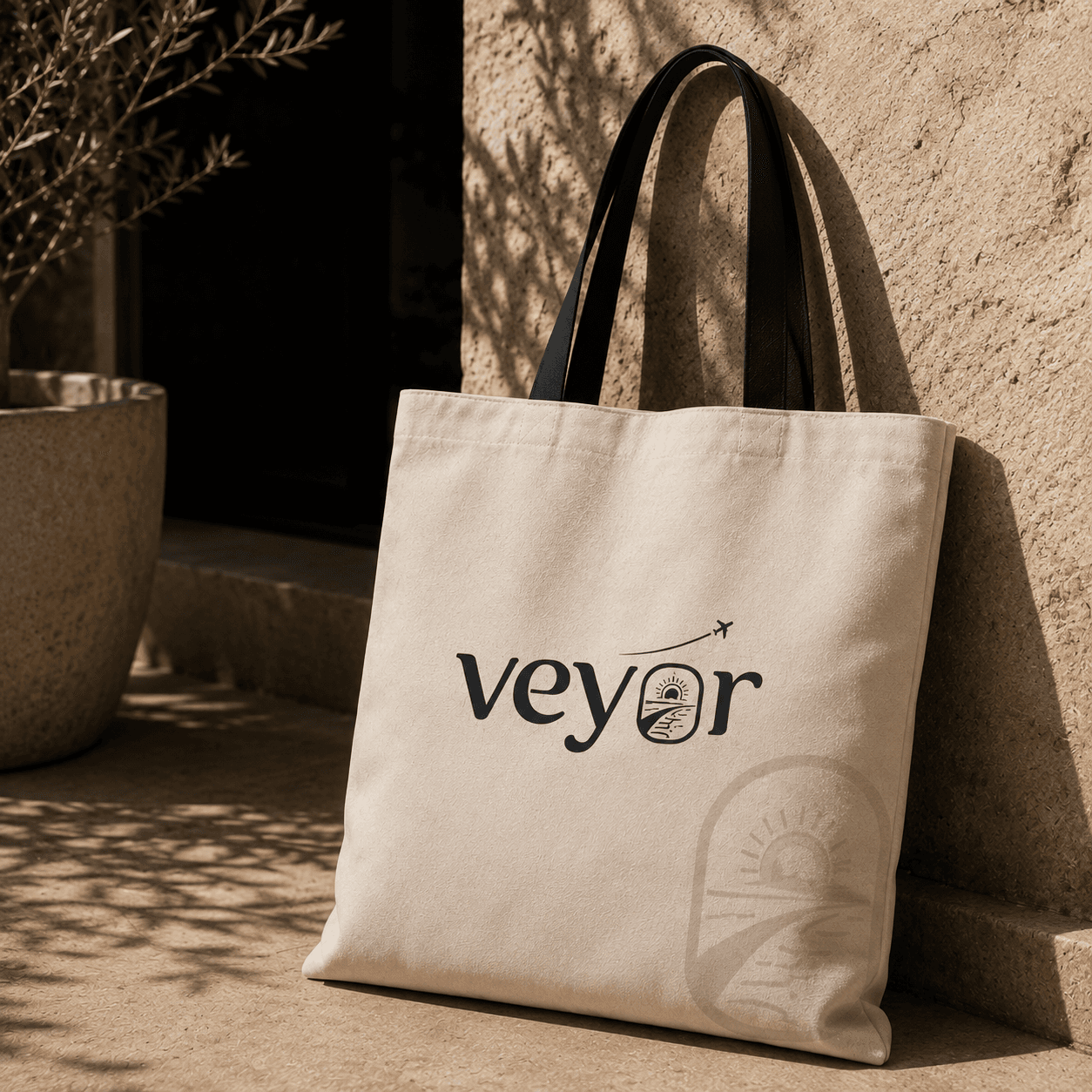 A branded canvas tote — the Veyor wordmark in black with the arch mark watermarked beside it